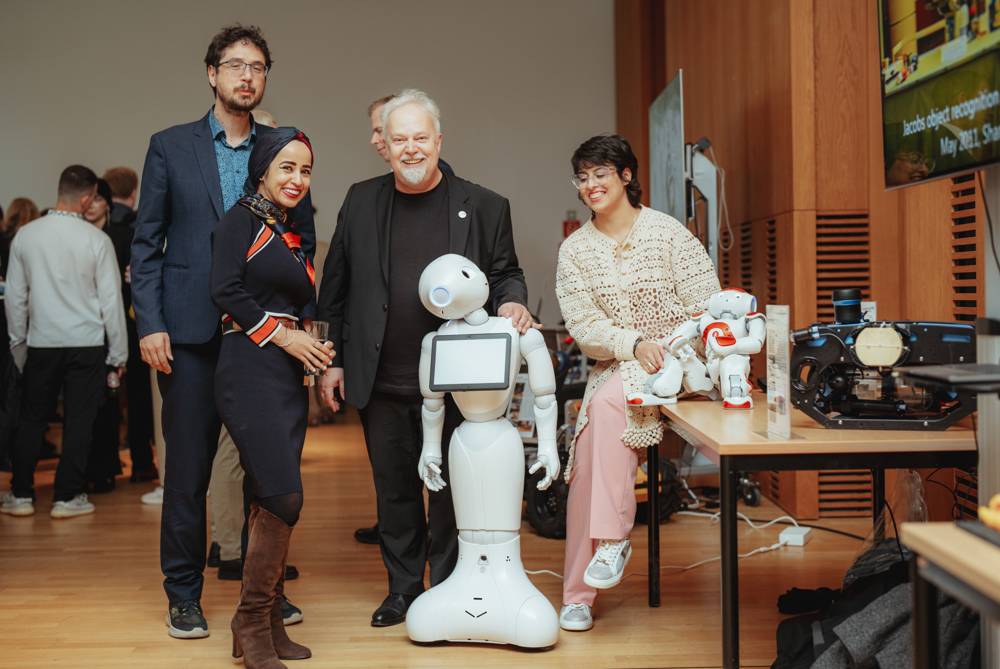 With the humanoid robots Pepper and NAO at a symposium reception